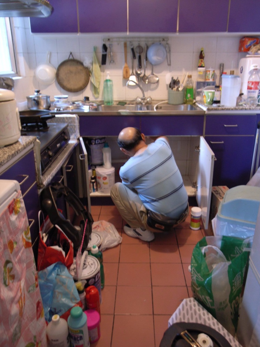 plumber working to unblock a sink