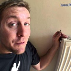 Image shows plumber explaining how to cure a cold radiator